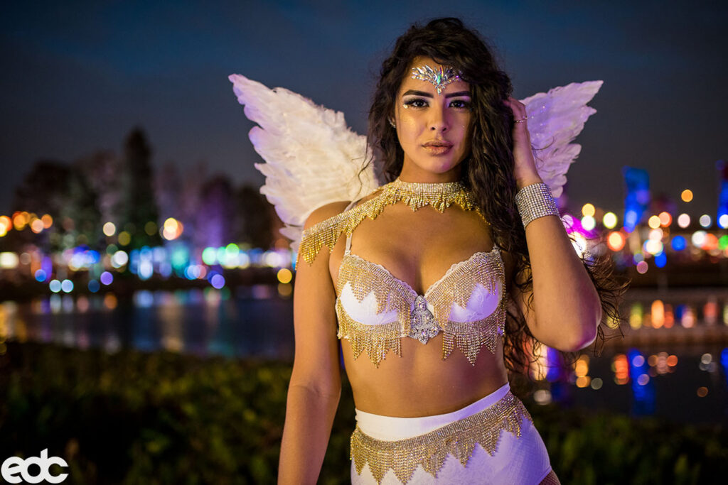 EDC Orlando Outfits For The Festival. Girl wearing angel look with wite wings and a white get up look.